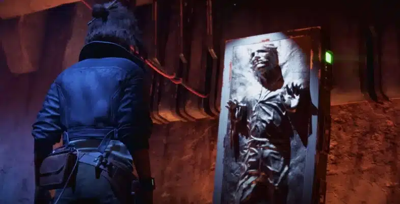 Kay Vesse face à Han Solo piégé dans la carbonite au Palais de Jabba, dans une pièce sombre éclairée par des lumières rouges.