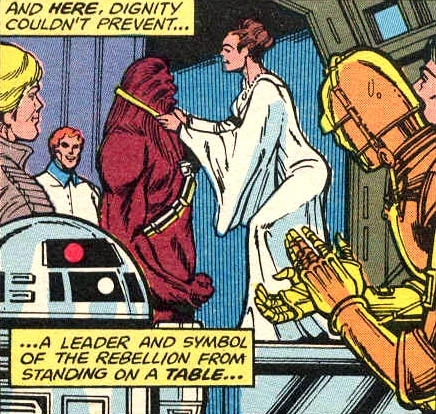 Leia Organa donnant la médaille à Chewbacca entouré de Luke, C-3PO, R2-D2 et un personnage inconnu.